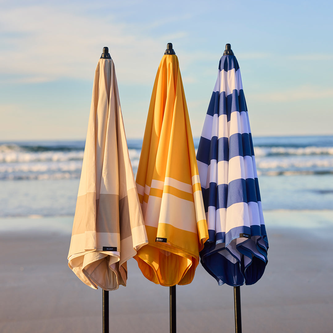 blunt | beach umbrella | sand