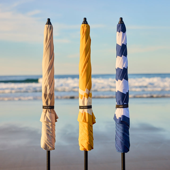 blunt | beach umbrella | sand