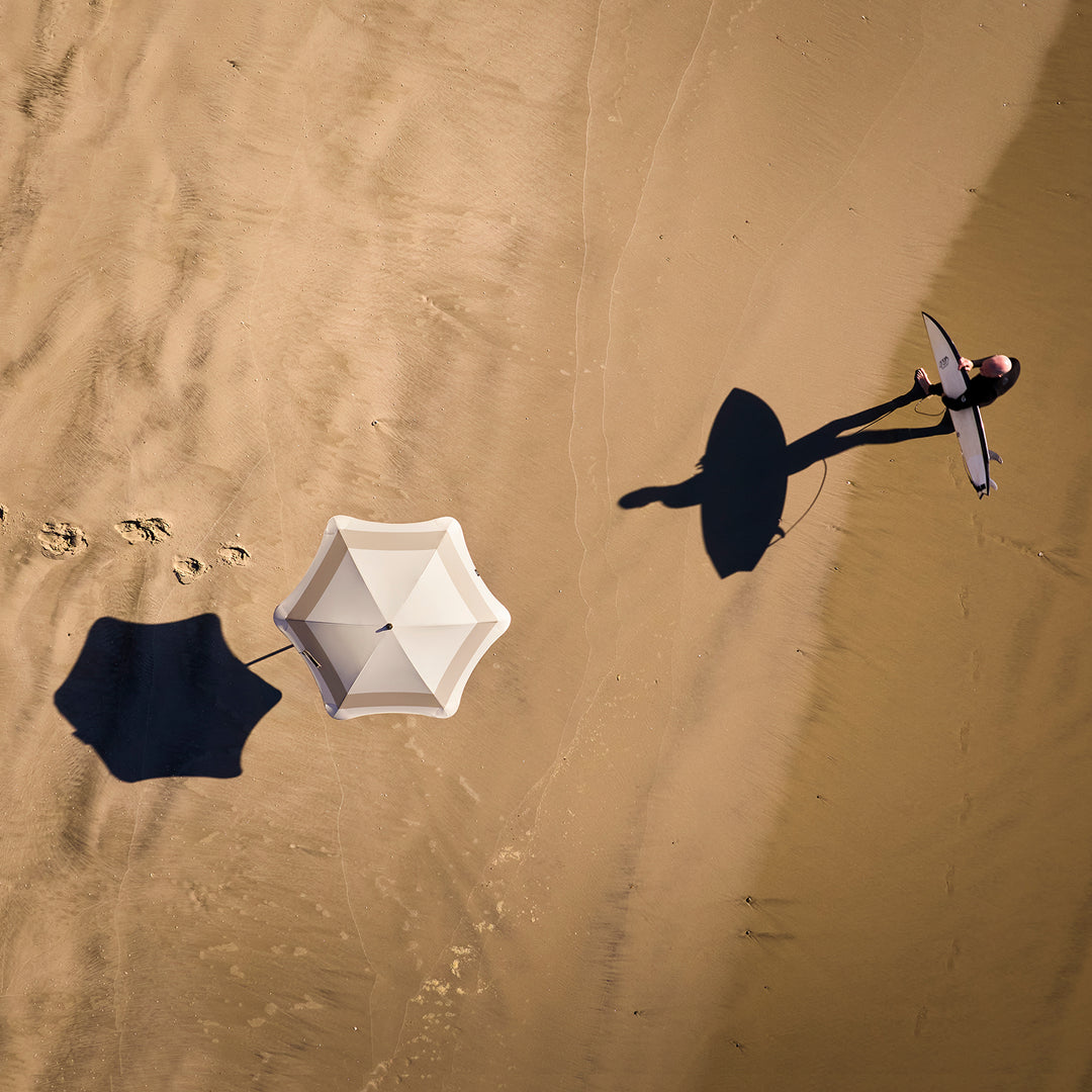 blunt | beach umbrella | sand