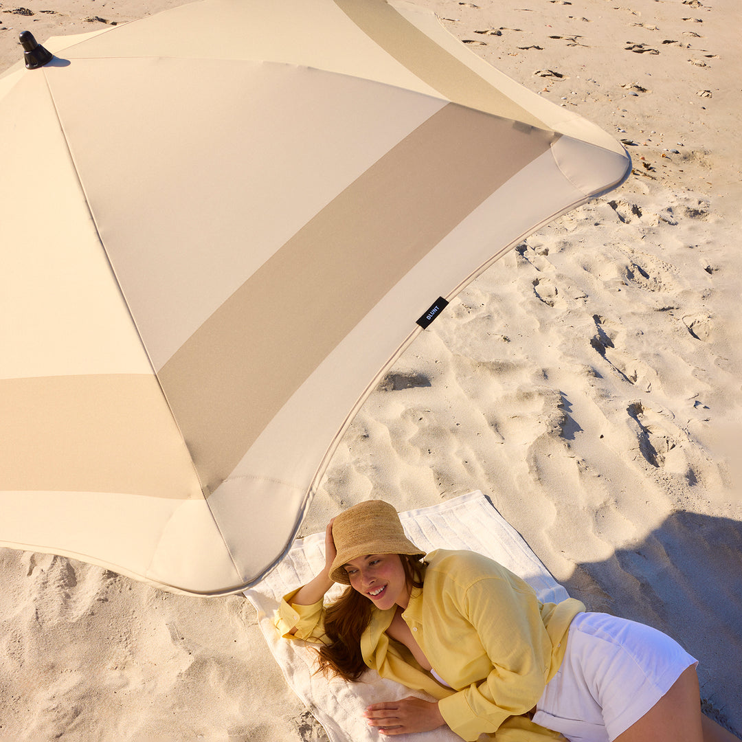 blunt | beach umbrella | sand